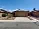 Charming single-story home with a two-car garage and low maintenance desert landscaping at 4017 Gliding Gulls Ave, North Las Vegas, NV 89084