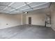 Spacious two-car garage with high ceilings and concrete flooring at 4017 Gliding Gulls Ave, North Las Vegas, NV 89084