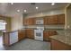 Bright kitchen with granite countertops, white appliances, and ample cabinet space at 4017 Gliding Gulls Ave, North Las Vegas, NV 89084