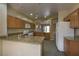 Well-lit kitchen featuring granite countertops and wooden cabinetry at 4017 Gliding Gulls Ave, North Las Vegas, NV 89084