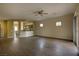 Open-concept living room with sleek flooring and access to the kitchen and sliding glass door at 4017 Gliding Gulls Ave, North Las Vegas, NV 89084