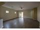 Spacious living room featuring sleek wood flooring and sliding glass door to the backyard at 4017 Gliding Gulls Ave, North Las Vegas, NV 89084