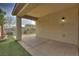 Covered patio with concrete flooring, stucco columns, and backyard access at 4017 Gliding Gulls Ave, North Las Vegas, NV 89084