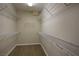 Spacious walk-in closet featuring wire shelving along the walls and wood-look flooring at 4017 Gliding Gulls Ave, North Las Vegas, NV 89084