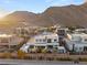 Scenic aerial view of luxury home with desert landscaping and mountain backdrop at 4024 Desert Trace Ct, Las Vegas, NV 89129