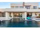 Expansive backyard with a sparkling pool, outdoor kitchen, and comfortable lounging spaces for year-round enjoyment at 4024 Desert Trace Ct, Las Vegas, NV 89129