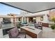 Amazing outdoor living space featuring a pool, covered patio, outdoor kitchen, and stylish seating areas, ideal for relaxation at 4024 Desert Trace Ct, Las Vegas, NV 89129