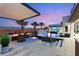 Outdoor living space featuring a pool, hot tub, covered patio, and fire pit at 4024 Desert Trace Ct, Las Vegas, NV 89129
