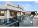 Stunning backyard featuring a modern pool, spa, outdoor kitchen, and elegant lounge areas, perfect for entertaining at 4024 Desert Trace Ct, Las Vegas, NV 89129