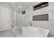 Sleek bathroom featuring a soaking tub and separate glass enclosed shower with contemporary design and fixtures at 4024 Desert Trace Ct, Las Vegas, NV 89129
