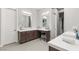 Bright bathroom offering dual sink vanities with a makeup area and tiled floors, and modern finishes at 4024 Desert Trace Ct, Las Vegas, NV 89129