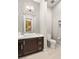 Contemporary half bathroom with modern vanity, stylish mirror, decorative tile, and tiled flooring at 4024 Desert Trace Ct, Las Vegas, NV 89129