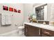 Elegant bathroom with modern vanity, sleek fixtures, artistic decor and a beautifully tiled shower enclosure at 4024 Desert Trace Ct, Las Vegas, NV 89129