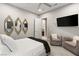 Cozy bedroom with stylish mirrors, a mounted TV, and comfortable seating, offering a relaxing space at 4024 Desert Trace Ct, Las Vegas, NV 89129