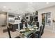 A formal dining room with a decorative chandelier and a view of the stairwell and entertainment area at 4024 Desert Trace Ct, Las Vegas, NV 89129