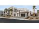Contemporary home featuring a multi-car garage, striking architecture, and lush landscaping for curb appeal at 4024 Desert Trace Ct, Las Vegas, NV 89129