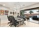 Inviting game room with a poker table, stylish lighting, and access to an outdoor pool and patio at 4024 Desert Trace Ct, Las Vegas, NV 89129