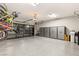 Well-lit garage featuring epoxy floors, side storage cabinets, and a transparent garage door at 4024 Desert Trace Ct, Las Vegas, NV 89129