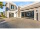 Modern home featuring a multi-car garage, desert landscaping, and great curb appeal for potential buyers at 4024 Desert Trace Ct, Las Vegas, NV 89129