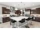 Gourmet kitchen features a large island, stainless steel appliances, custom cabinets, and elegant pendant lighting at 4024 Desert Trace Ct, Las Vegas, NV 89129