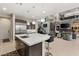 Spacious kitchen island overlooks the open-concept living space with fireplace and large windows, perfect for entertaining at 4024 Desert Trace Ct, Las Vegas, NV 89129