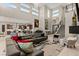 Spacious living area with open floor plan, grand piano, modern decor, and a staircase at 4024 Desert Trace Ct, Las Vegas, NV 89129