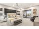 This main bedroom boasts a private balcony, stylish accent wall, and a neutral color palette at 4024 Desert Trace Ct, Las Vegas, NV 89129