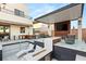 Chic outdoor kitchen and lounge area with a built-in grill, bar, and cozy seating, perfect for gatherings at 4024 Desert Trace Ct, Las Vegas, NV 89129