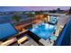 Aerial view showcasing the pool with a waterfall feature, fire pit, and modern outdoor furniture at 4024 Desert Trace Ct, Las Vegas, NV 89129