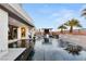 Beautiful pool with a waterfall feature surrounded by lush landscaping and stylish outdoor seating areas at 4024 Desert Trace Ct, Las Vegas, NV 89129