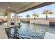 Inviting backyard pool area with built-in water features, palm trees, and a serene lounge space at 4024 Desert Trace Ct, Las Vegas, NV 89129