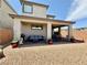 Outdoor living space features a covered patio, grill, and low-maintenance gravel landscaping at 4132 Ancient Well Ct, Las Vegas, NV 89135