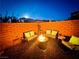Charming backyard space with a central fire pit and ample seating perfect for relaxing evenings at 4132 Ancient Well Ct, Las Vegas, NV 89135