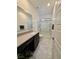 Bright bathroom with a glass enclosed shower, vanity with solid surface tops, and a tile floor at 4132 Ancient Well Ct, Las Vegas, NV 89135