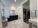 Bright bathroom featuring dual vanities, a glass-enclosed shower, and a makeup vanity with a view to the closet at 4132 Ancient Well Ct, Las Vegas, NV 89135