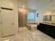 Full bathroom featuring a walk in shower, tub, double vanity, and tile flooring at 4132 Ancient Well Ct, Las Vegas, NV 89135
