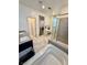 Bright bathroom featuring dual vanities, a soaking tub, glass enclosed shower, and a makeup vanity at 4132 Ancient Well Ct, Las Vegas, NV 89135