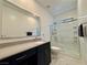 Well lit bathroom with walk-in shower, solid surface vanity with a sink, and marble look tile floors at 4132 Ancient Well Ct, Las Vegas, NV 89135
