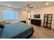 Spacious bedroom features a window, ceiling fan, and hard surface flooring for a clean, contemporary look at 4132 Ancient Well Ct, Las Vegas, NV 89135