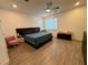 Cozy bedroom with a ceiling fan, wooden floors, and natural light, creating a peaceful atmosphere at 4132 Ancient Well Ct, Las Vegas, NV 89135