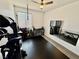 Well-equipped home gym features exercise equipment, rubber flooring, and a wall mirror at 4132 Ancient Well Ct, Las Vegas, NV 89135