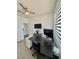 Well lit office space featuring a black desk, modern gray cabinets, and wood-look floors, perfect for remote work at 4132 Ancient Well Ct, Las Vegas, NV 89135