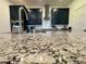 Close-up of the granite countertops and stainless steel faucet in the updated kitchen at 4132 Ancient Well Ct, Las Vegas, NV 89135
