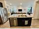 Open floor plan featuring a kitchen island with stainless steel appliances and granite countertops at 4132 Ancient Well Ct, Las Vegas, NV 89135