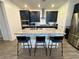 Modern kitchen with stainless steel appliances, dark cabinetry, and a center island with bar seating at 4132 Ancient Well Ct, Las Vegas, NV 89135