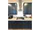 The kitchen features dark cabinets, granite countertops and stainless steel appliances at 4132 Ancient Well Ct, Las Vegas, NV 89135
