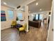 Bright and airy living area featuring wood-look floors, large windows, and comfortable furnishings at 4132 Ancient Well Ct, Las Vegas, NV 89135
