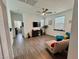 Spacious living room with hardwood floors, ceiling fan, and modern furnishings at 4132 Ancient Well Ct, Las Vegas, NV 89135