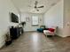 Bright living room boasts hardwood floors, modern decor, and a ceiling fan at 4132 Ancient Well Ct, Las Vegas, NV 89135