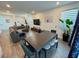 The living room features a sectional sofa, TV, plants and large windows at 4132 Ancient Well Ct, Las Vegas, NV 89135